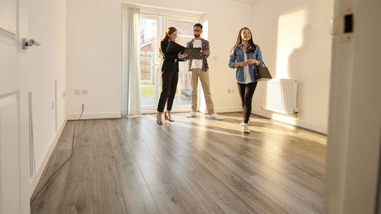 Realtor showing buyers empty room