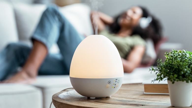 Essential oil diffuser near woman