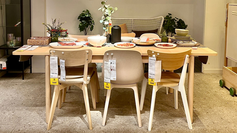 wood dining table with chairs display room at IKEA
