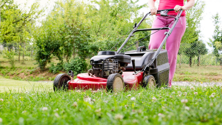 Woman pushing mower