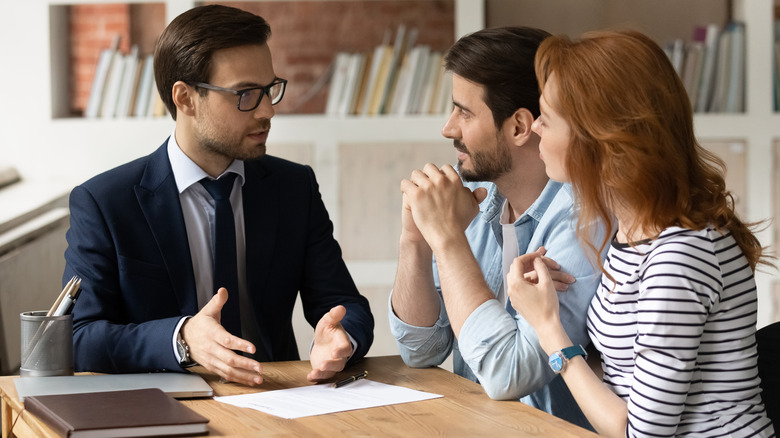 three people at a desk