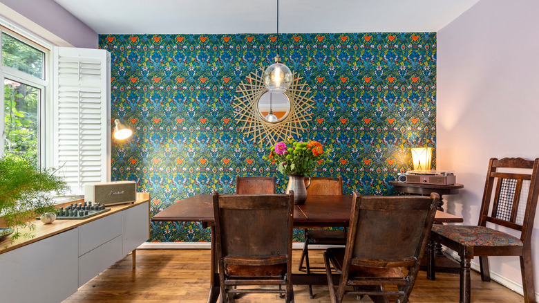 Dining room with bold wallpaper on accent wall