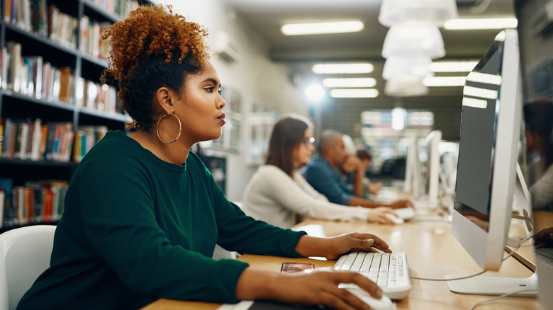 Person researching on a library computer