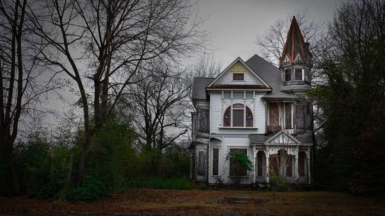 Creepy old white house on a dark, gloomy day