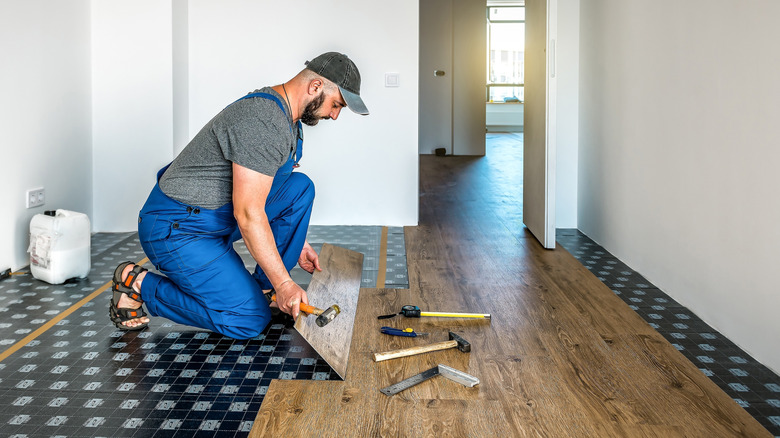 Floor installer installing vinyl plank floors
