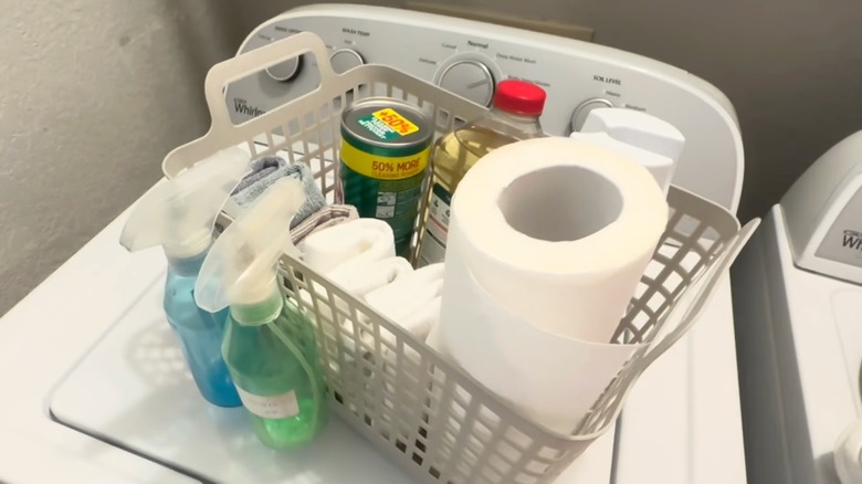 Dollar Tree basket filled with cleaning supplies, placed on top of a washing machine.
