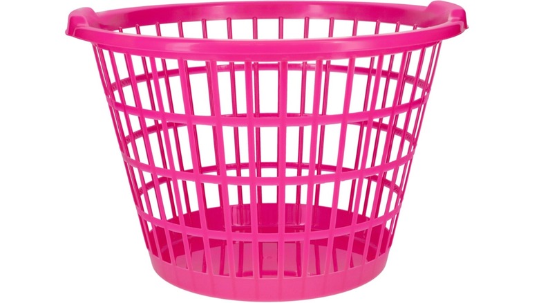 Hot pink Dollar Tree plastic laundry basket displayed against a white background.