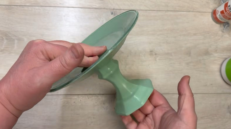 Creator holds a simple tray painted green