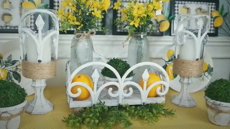 Two elevated candle holders sitting on either side of a matching DIY tray