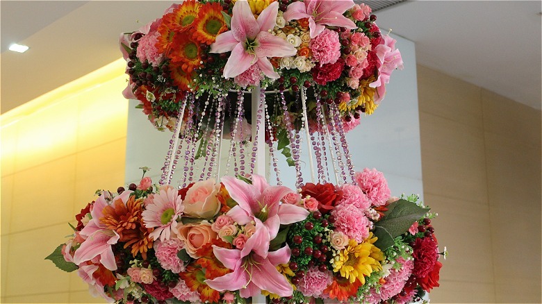 A floral topiary featuring several kinds of flowers and greenery