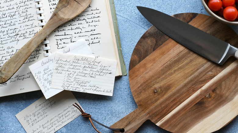 Cutting board with old-fashioned recipe cards nearby