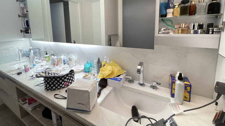 Messy cluttered bathroom countertop