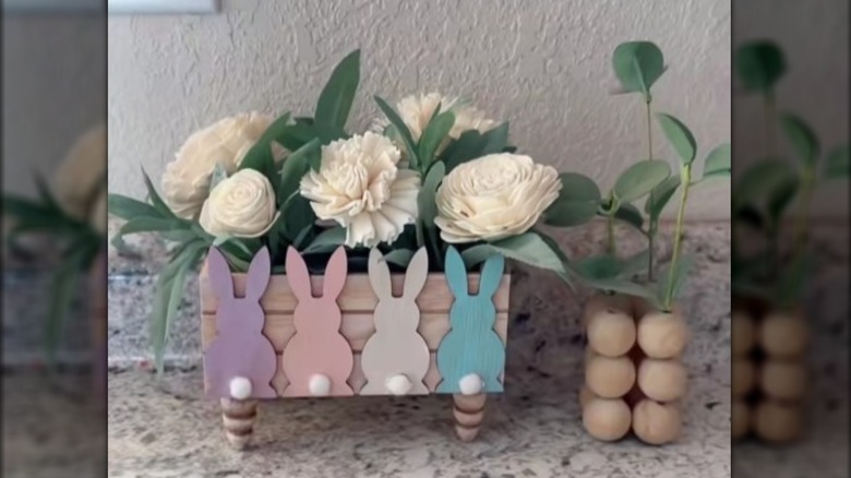 spring container featuring painter bunnies