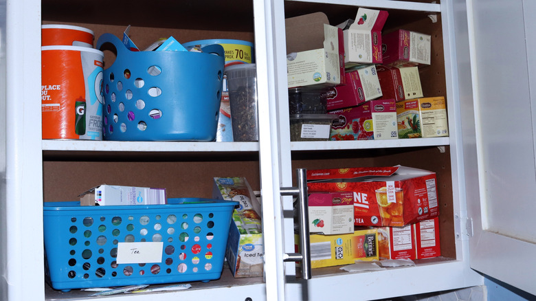 A cluttered kitchen cabinet