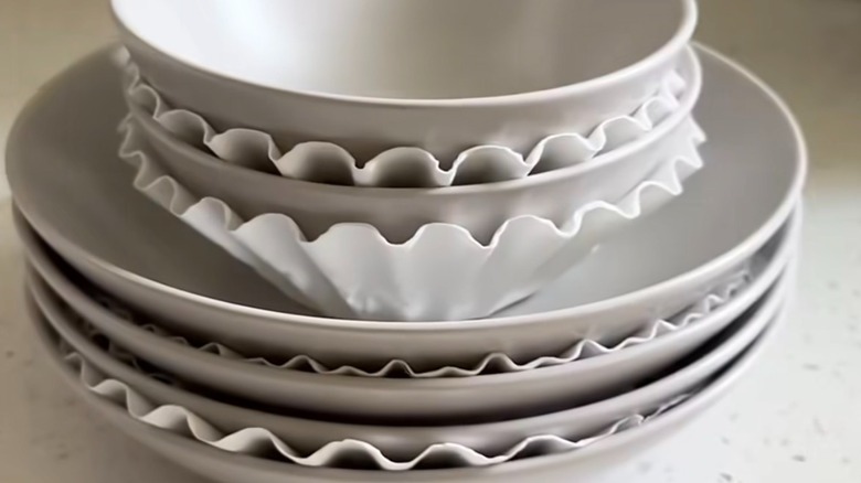 Coffee filters placed between plates and bowls