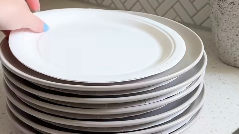 Paper plates placed between stacked plates