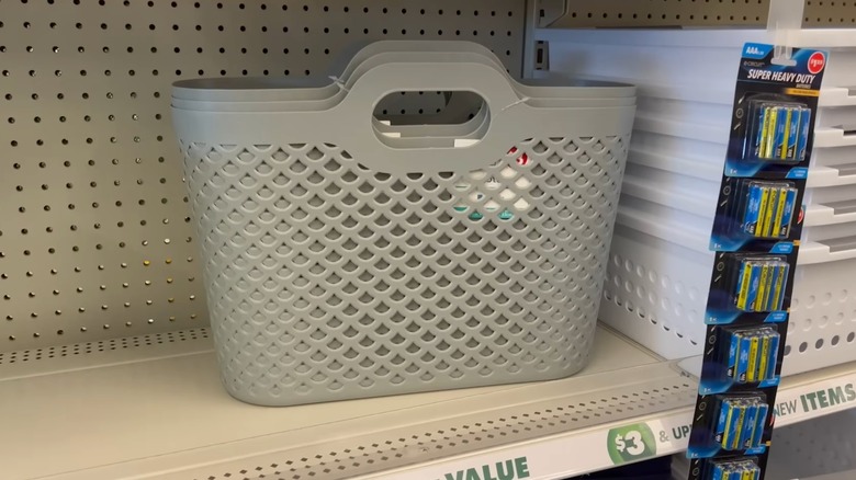 Gray plastic storage basket on shelf