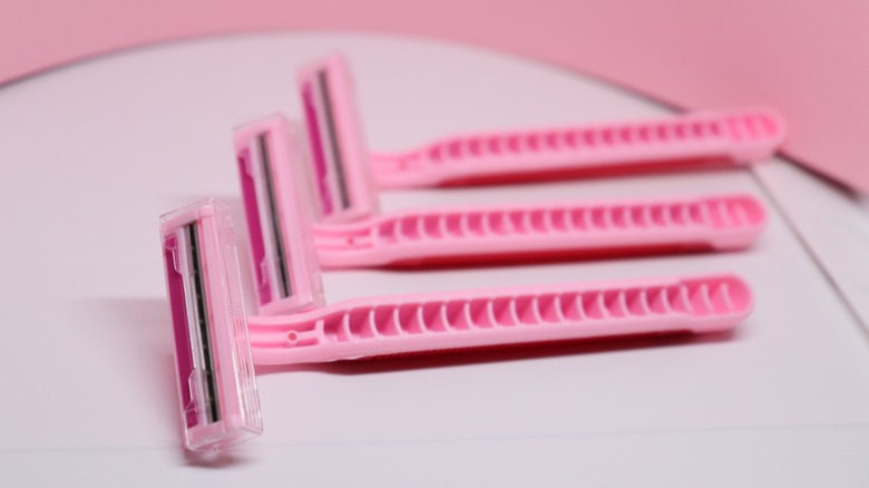 three pink two-blade razors
