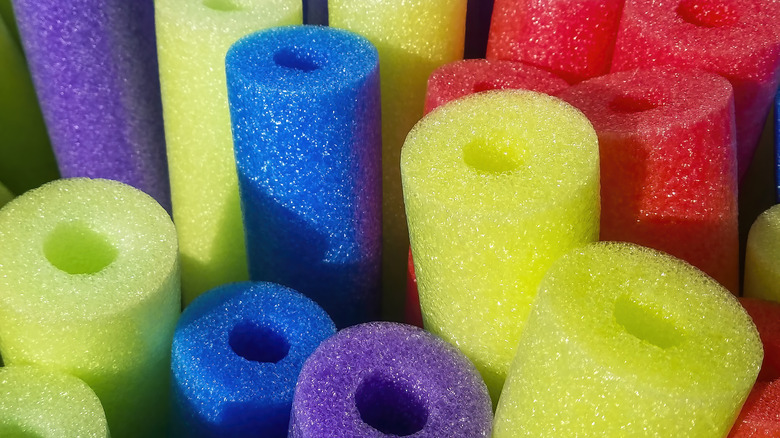 close up of multiple colors of pool noodles