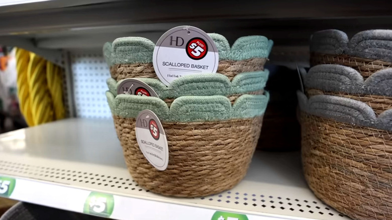 Various woven baskets, some with pastel tips that look like flowers, sit on a Dollar Tree shelf
