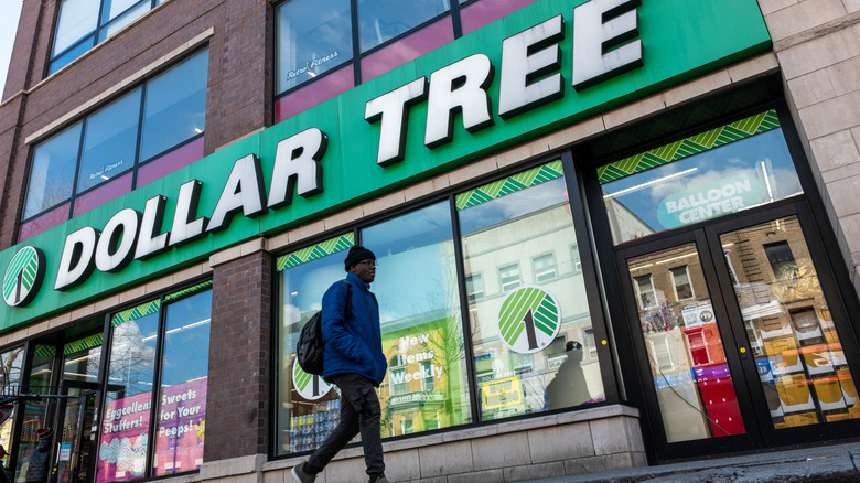 Man walking by a Dollar Tree storefront