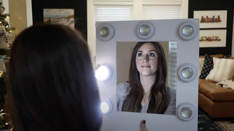 The person is looking into the mirror that they created with the push lights