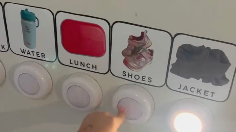A child is pushing the push light on their visual schedule