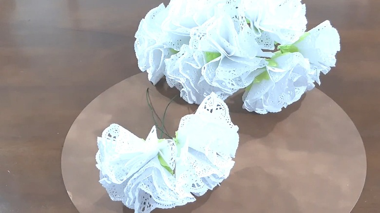 Bouquet of paper doily flowers laying on a table