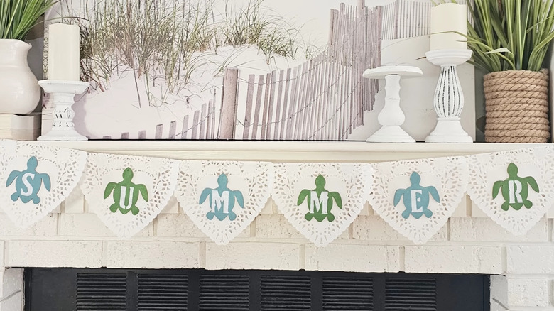 Summer-themed bunting made of paper doilies with turtle shapes and the word "summer"