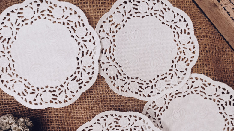 White paper doilies on a burlap background