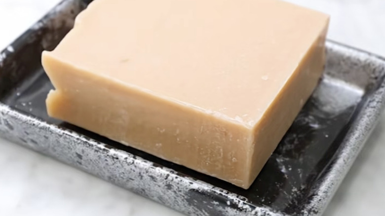 Marble look soap holder with a bar of natural soap in it.