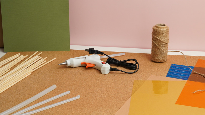 A hot glue gun on a craft table