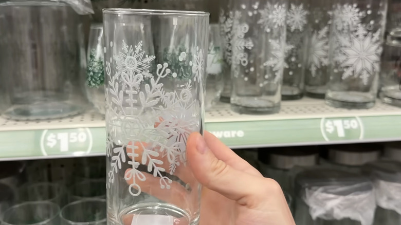 hand holding a holiday glass picked up from a shelf at the Dollar Tree