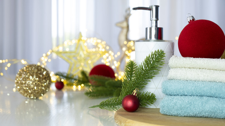 Folded towels, soap dispenser, and holiday decor on countertop