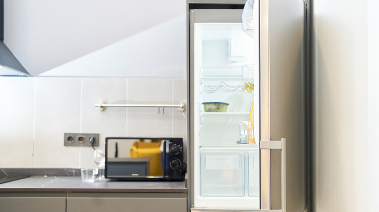 Opened fridge in a modern kitchen