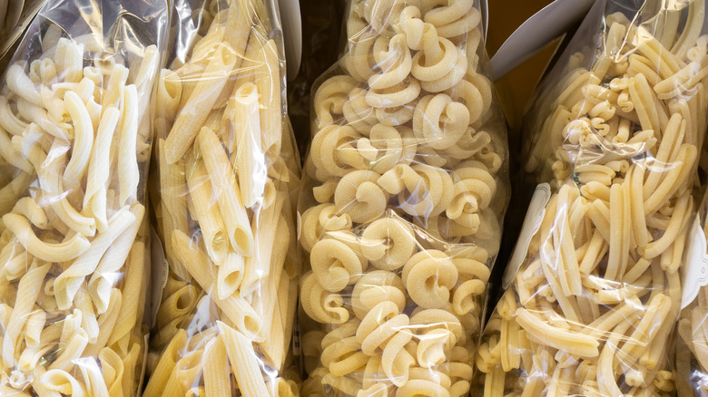 dry pasta in clear bags on shelf