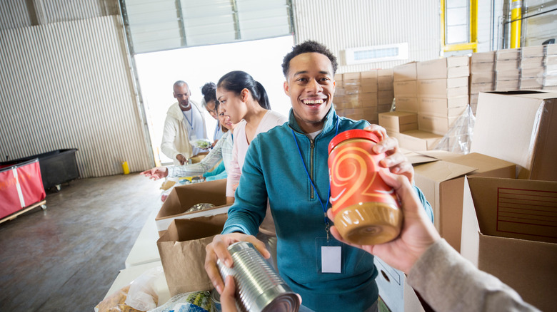 Volunteer sorting peanut butter during food drive
