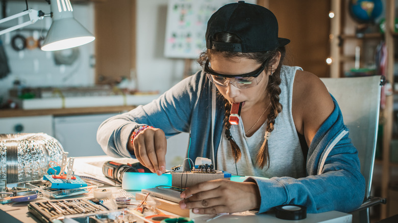 young woman connecting wires