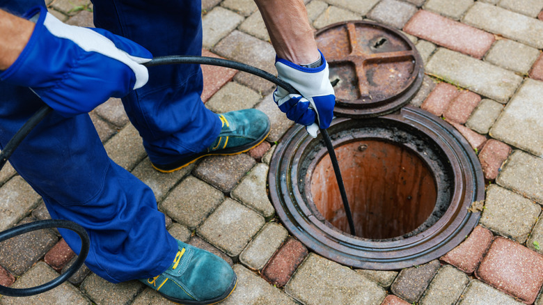 A plumber flushing sewage 