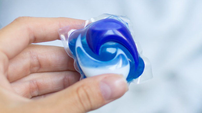 Woman holding detergent pod