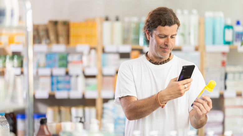 Man reading up on the ingredients of an insect repellent