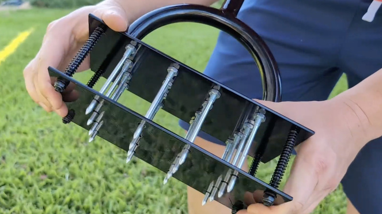 Closeup of a lawn aerator with a double plate design