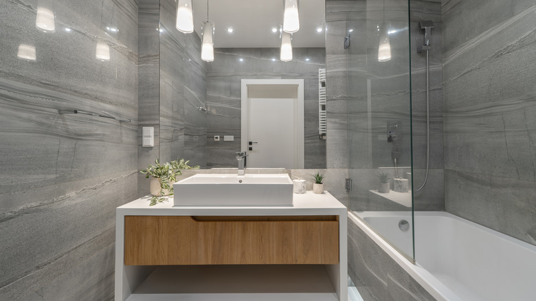 Grey bathroom design with harsh overhead lights