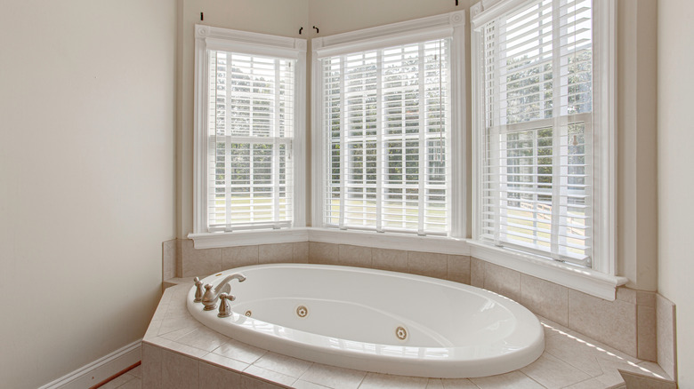 Tiled Jet bathtub against a bay window