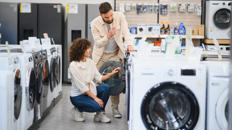 A couple shopping for a washing machine