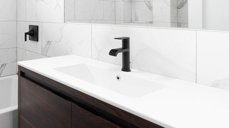 white bathroom with brown cabinet