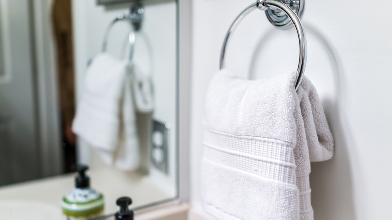 Modern bathroom with one towel hanging on a rack