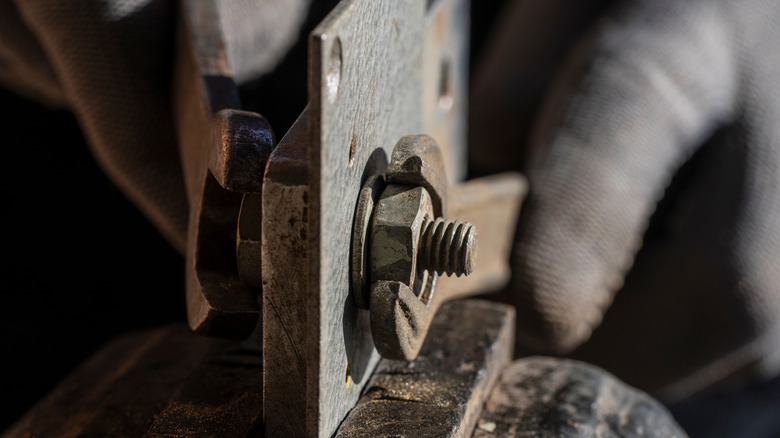 Removing bolt with wrenches