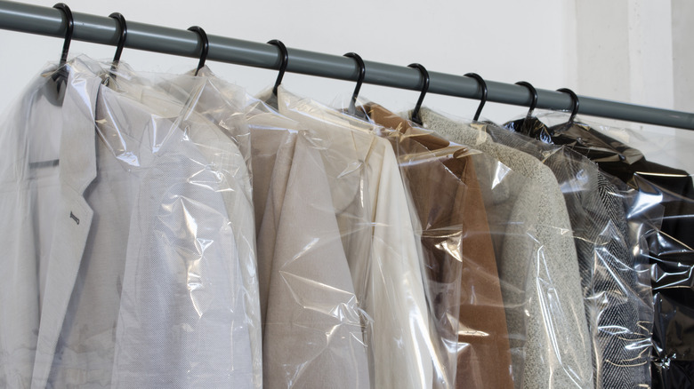 Coats in plastic garment bags