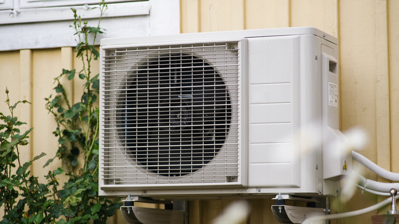 An AC unit attached to a residential exterior